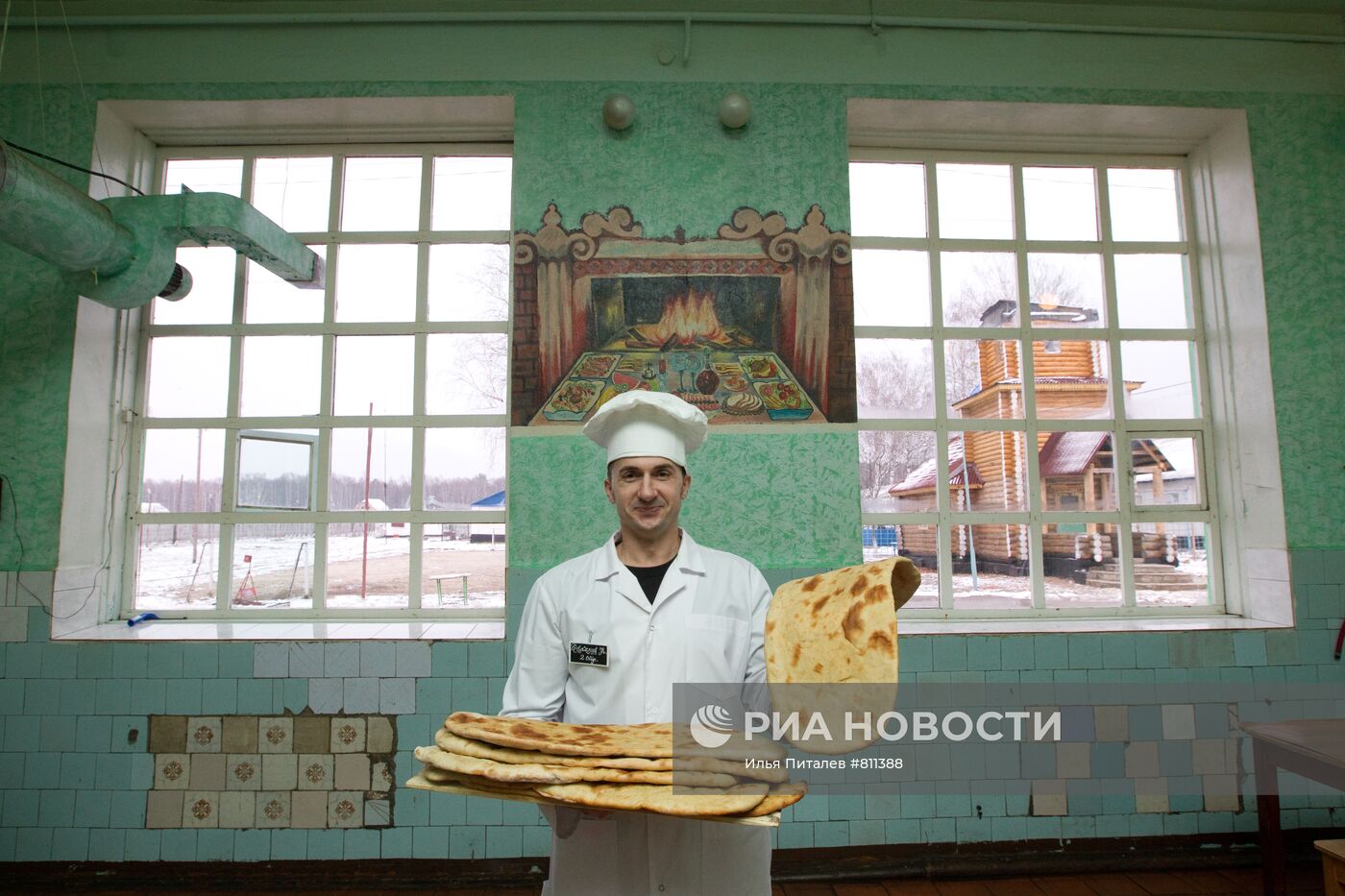 Повар-заключенный показывает испеченный им хлеб