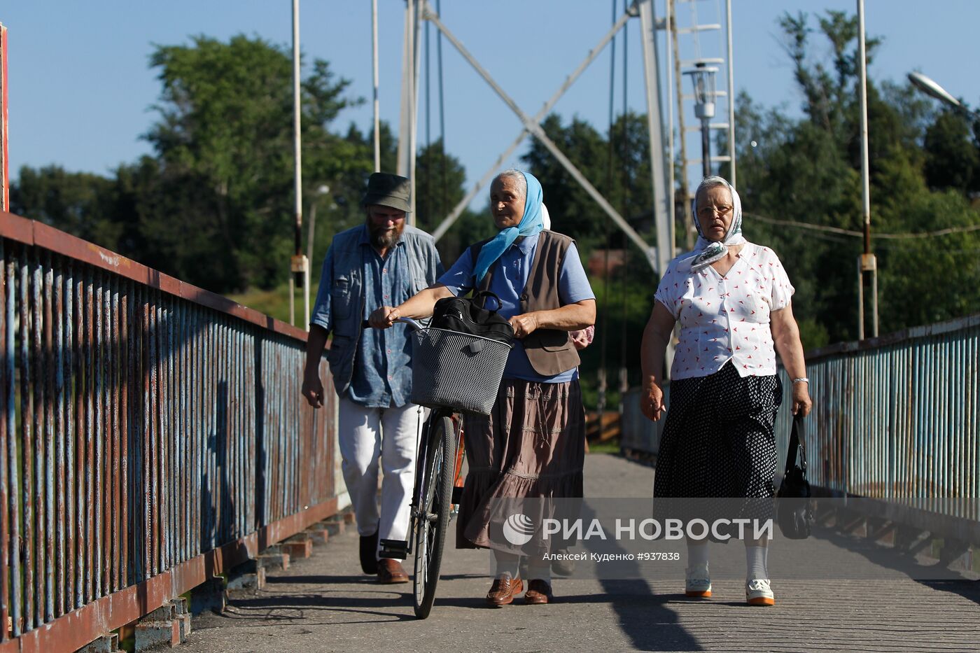 Жители города Шуи идут по пешеходному мосту через реку Тезу