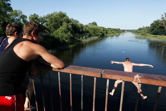 Мальчишки прыгают с пешеходного моста через реку Тезу в Шуе