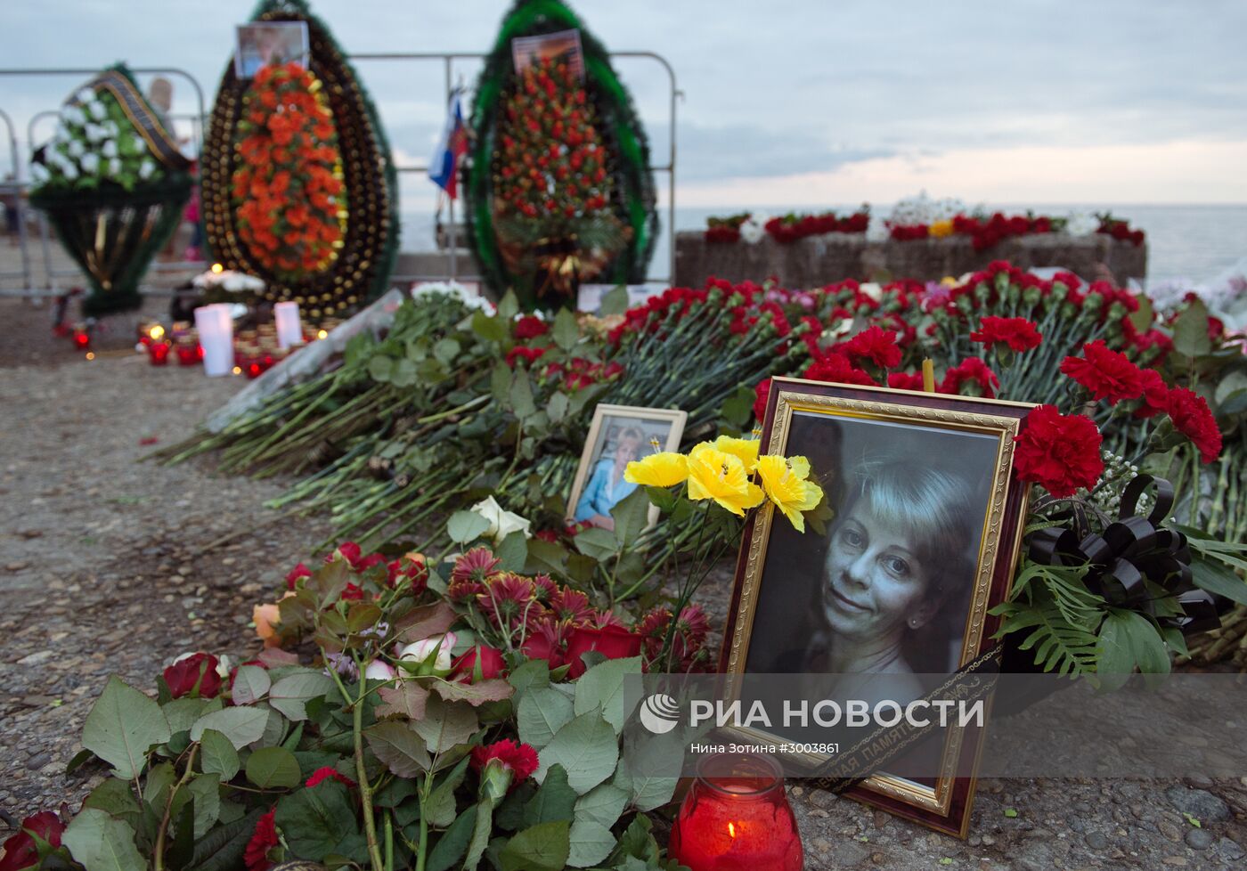 В Сочи жители города несут цветы и свечи к площади Южного мола морского порта