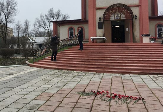 Жители несут цветы к Свято-Георгиевскому храму в Кизляре