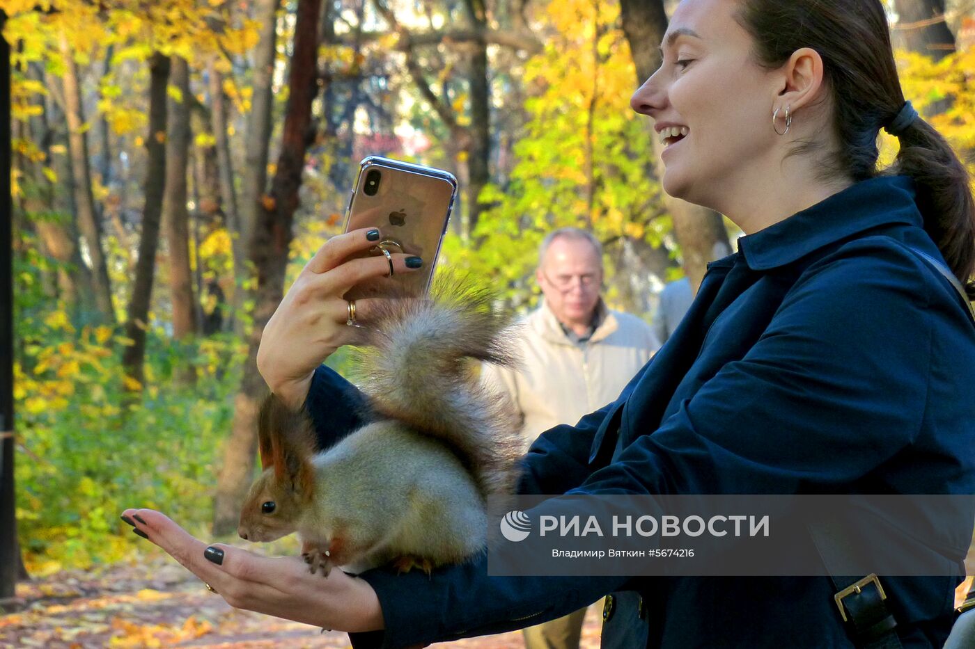 Женщина фотографируется с белкой в Нескучном саду в Москве. Место: Россия, Москва. Автор: Владимир Вяткин/РИА Новости. Осень в Москве