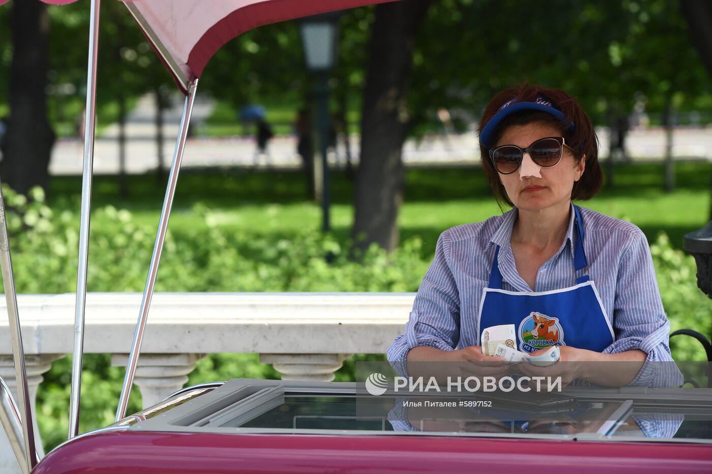 Продавец мороженого в Александровском саду в Москве. В столичный регион пришла аномально жаркая погода. 29 мая ожидается сильная жара с повышением температуры до плюс 30-31 градуса по Цельсию. Место: Россия, Москва. Автор: Илья Питалев/РИА Новости. Жара в Москве