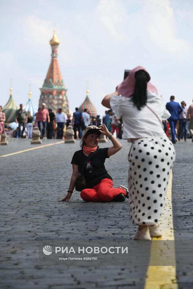 Туристы фотографируются на Красной площади в Москве. В столичный регион пришла аномально жаркая погода. 29 мая ожидается сильная жара с повышением температуры до плюс 30-31 градуса по Цельсию. Место: Россия, Москва. Автор: Илья Питалев/РИА Новости. Жара в Москве