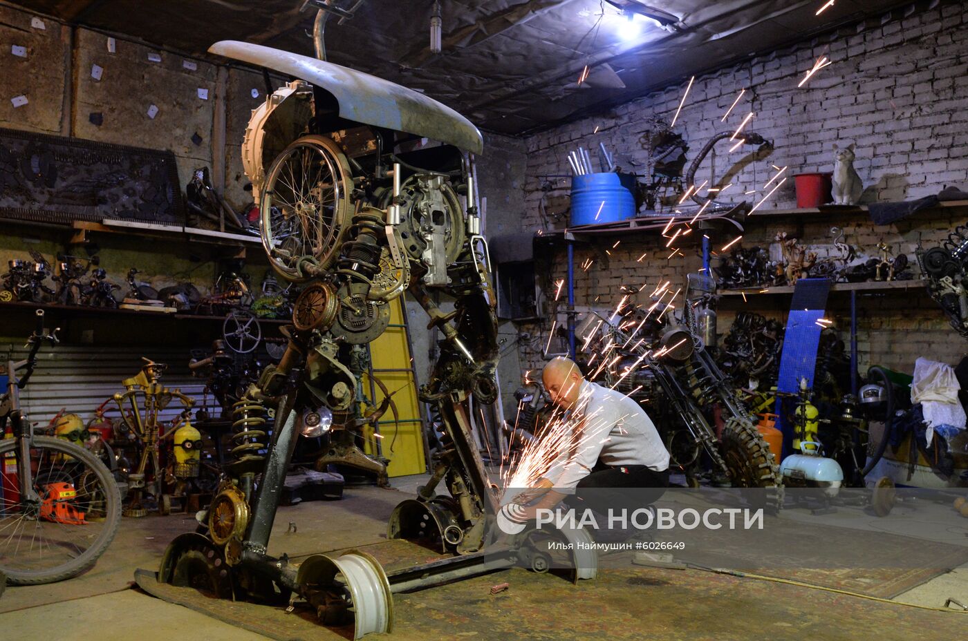 Автослесарь Сергей Кулагин во время создания новой скульптуры из отслуживших автомобильных деталей в автосервисе-музее "Восстание машин" в Дивногорске. Место: Россия, Красноярский край, Дивногорск. Автор: Илья Наймушин/РИА Новости. Выставка металлических скульптур из автомобильных запчастей в Дивногорске
